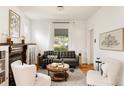 Bright living room featuring hardwood floors, a cozy sofa, and stylish decor at 4224 N Clay St, Denver, CO 80211