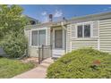 Close-up of a well-maintained home featuring a charming front entrance with an evergreen bush at 16149 E Rice Pl # A, Aurora, CO 80015