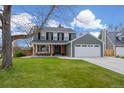 Lovely two-story home featuring a double door entry and attached two-car garage at 9391 W Hialeah Pl, Littleton, CO 80123