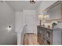 Hallway with a cabinet, mirror, lamp and wood-style floors at 10380 W 55Th Ln # 204, Arvada, CO 80002