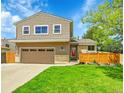Traditional two-story home showcasing a well-maintained lawn and a two car garage at 12433 Bellaire Dr, Thornton, CO 80241