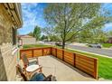 Relaxing outdoor patio area with chairs, table, and wooden fence at 12433 Bellaire Dr, Thornton, CO 80241