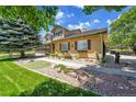 Charming home featuring well-manicured landscaping, flower boxes and a stone walkway at 25741 E Kettle Cir, Aurora, CO 80016