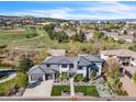 An aerial view of a modern home, showcasing its landscaping, a large yard, and its place in a quiet suburban neighborhood at 10095 S Shadow Hill Dr, Lone Tree, CO 80124
