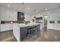 A spacious kitchen features a large island with seating, pendant lighting, and stainless steel appliances at 10095 S Shadow Hill Dr, Lone Tree, CO 80124