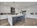 A spacious kitchen features a large island with seating, pendant lighting, and stainless steel appliances at 10095 S Shadow Hill Dr, Lone Tree, CO 80124