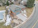 Aerial view of a two-story home with a brick exterior and a well-maintained front and side yard at 1513 S Beech St, Lakewood, CO 80228