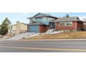 Two-story home features brick accents, an attached garage, and a well-maintained front yard at 1513 S Beech St, Lakewood, CO 80228