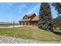 Exterior shot of a home with a three-car garage and a beautifully landscaped yard at 6279 Cheyenne Ct, Parker, CO 80134
