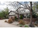 Charming home exterior featuring a pergola, a manicured lawn, and a detached garage at 479 Blue Lake Trl, Lafayette, CO 80026