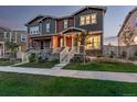 Beautiful exterior of a multi-story home with a well-manicured lawn and inviting front porch at 13860 Ash Cir, Thornton, CO 80602