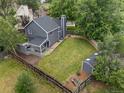 Aerial view of a fully fenced backyard with a large lawn, storage shed, and wooden deck at 18056 E Bellewood Dr, Aurora, CO 80015