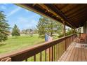 Enjoy tranquil views from this balcony, complete with a charming American flag, overlooking a lush landscape at 34101 Columbine E Trl, Elizabeth, CO 80107