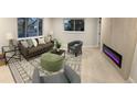 Inviting living room with modern decor, a cozy sofa, and a stylish electric fireplace at 6511 S Cedar St, Littleton, CO 80120