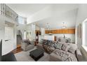 Bright living room with high ceilings, open layout to the kitchen, and stylish modern furnishings at 22501 E Belleview Pl, Aurora, CO 80015