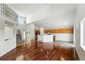 Bright living room with high ceilings, open layout to the kitchen, and beautiful hardwood floors at 22501 E Belleview Pl, Aurora, CO 80015
