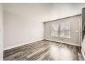 Bright living room with wood-look floors and large windows at 16373 E 17Th Pl # B, Aurora, CO 80011