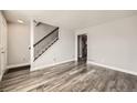 Living room with wood-look floors and a staircase at 16373 E 17Th Pl # B, Aurora, CO 80011