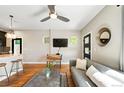 Cozy living area with a gray couch, modern rug, and a view into the open kitchen at 2645 W 24Th Ave, Denver, CO 80211