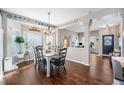 Bright dining area with hardwood floors and a charming farmhouse table at 5907 E Tabor Pl, Castle Rock, CO 80104