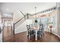 Bright dining area with hardwood floors and a charming farmhouse table at 5907 E Tabor Pl, Castle Rock, CO 80104