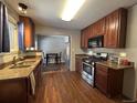 Traditional kitchen featuring wood cabinets, granite counters, and stainless steel appliances at 921 Dakin St, Denver, CO 80221