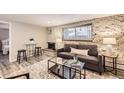 Spacious living room with a fireplace and view into bedroom at 625 N Pennsylvania St # 108, Denver, CO 80203