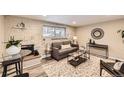 Living room features a fireplace, gray couch, and wood-look floors at 625 N Pennsylvania St # 108, Denver, CO 80203