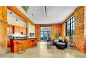Inviting open-concept living space features exposed brick walls, industrial accents, and modern furnishings at 2500 Walnut St # 102, Denver, CO 80205