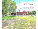 Spacious backyard with a lush lawn, beautiful trees, and an inviting outdoor space for relaxation at 8030 Ogden St, Denver, CO 80229