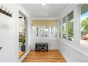 Bright entryway featuring hardwood floors, windows, and seating area with storage racks for shoes at 4501 Zenobia St, Denver, CO 80212