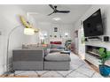 Comfortable living room with a gray sectional couch, modern lighting, and electric fireplace at 4501 Zenobia St, Denver, CO 80212