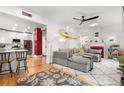 Open-concept living space with modern gray couch, overhead fan, and modern decor at 4501 Zenobia St, Denver, CO 80212