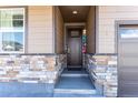 Inviting front entrance with stylish stone accents and a covered porch at 2149 Indian Balsam Dr, Monument, CO 80132