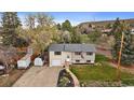 Aerial view of a split-level home with a trailer, shed, and well-maintained lawn and landscaping at 31 Circle Dr, Castle Rock, CO 80104