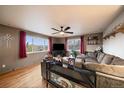 Cozy living room with hardwood floors, large windows, and comfortable sectional seating at 31 Circle Dr, Castle Rock, CO 80104