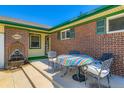 Inviting front patio with outdoor seating and decorative water fountain feature at 10684 Downing St, Northglenn, CO 80233
