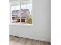 Bright interior view of a window overlooking a neighboring house at 45940 Gentry Ave, Bennett, CO 80102