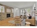 Bright living room featuring hardwood floors, a modern stone fireplace, and ample natural light at 5887 S Taft Ln, Littleton, CO 80127
