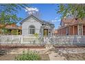 Charming home featuring a white picket fence, lush greenery, and a welcoming walkway at 3042 N Franklin St, Denver, CO 80205