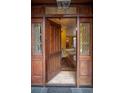Open foyer with decorative sidelights and an intricate transom lets natural light stream through at 445 Madison N St, Denver, CO 80206