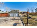 Inviting home with a two-car garage, brick accents, and a tidy front yard, complete with a vintage mailbox at 10596 Ura Ln, Northglenn, CO 80234