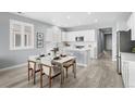 This eat-in kitchen offers an island and dining area with views into an open-concept kitchen and living space at 55 S Edge Cliff St, Castle Rock, CO 80104