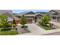 This single-Gathering home showcases meticulous landscaping, a convenient two-car garage, and an inviting entrance at 55 S Edge Cliff St, Castle Rock, CO 80104