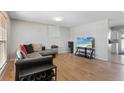 A well-lit living room with hardwood floors and a comfortable sectional sofa at 1655 S Quintero Way, Aurora, CO 80017