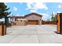 Inviting home with a modern garage door, gated driveway, and charming curb appeal at 3595 W 67Th S Ave, Denver, CO 80221