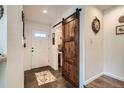 Welcoming entryway with a rustic barn door and tiled flooring at 5843 Ceylon St, Denver, CO 80249