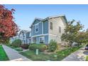 Charming townhouse exterior with well-maintained landscaping and blue siding at 5843 Ceylon St, Denver, CO 80249