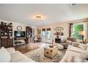 Comfortable living room with hardwood floors, fireplace, and stylish decor at 5843 Ceylon St, Denver, CO 80249
