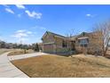 Well-maintained single-story home featuring a two-car garage and lawn at 4561 Hope Cir, Broomfield, CO 80023